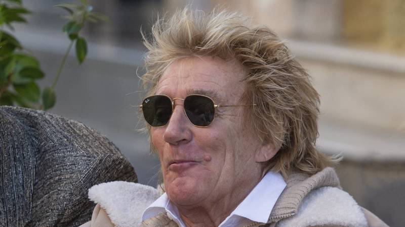 Rod Stewart, 78, looks cheerful while tucking into an ice cream cone with his son Alistair as they continue his 18th birthday celebrations in Rome